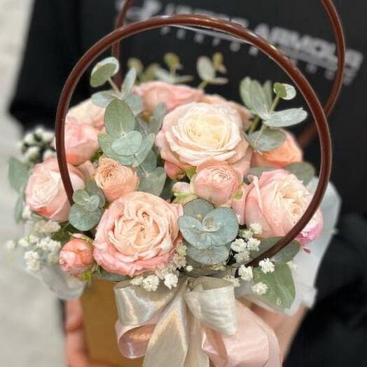 Bush rose in a handbag with eucalyptus