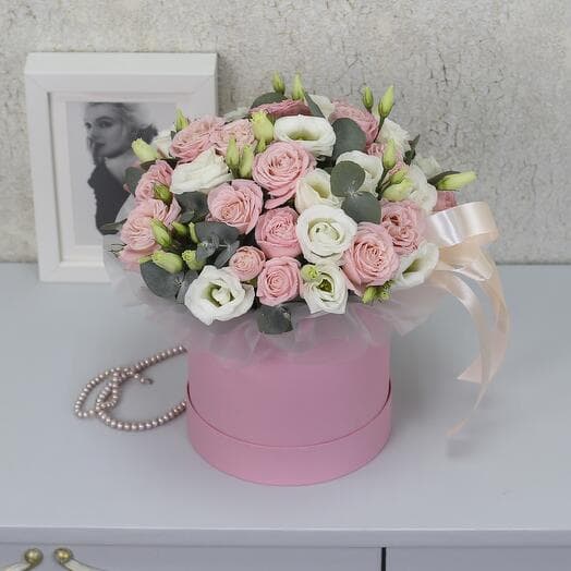 White eastomas and pionivate roses with eucalyptus in the box "Tender Message"