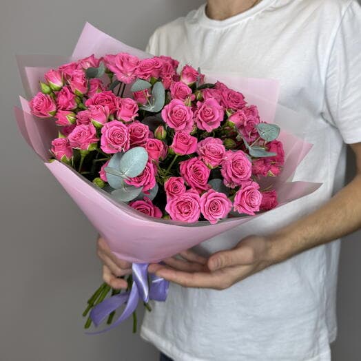 Bouquet of raspberry bush roses with eucalyptus