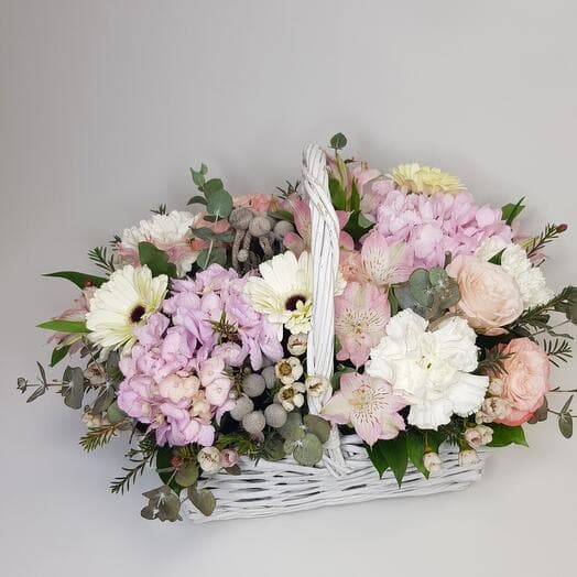 Big basket with flowers in delicate colors