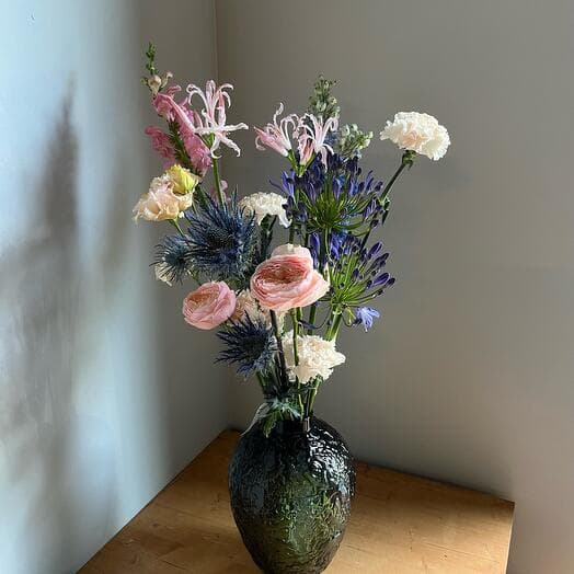 Interior bouquet with Nerin Dolphinium Agapantus Diantus Pionovid roses and Eringium