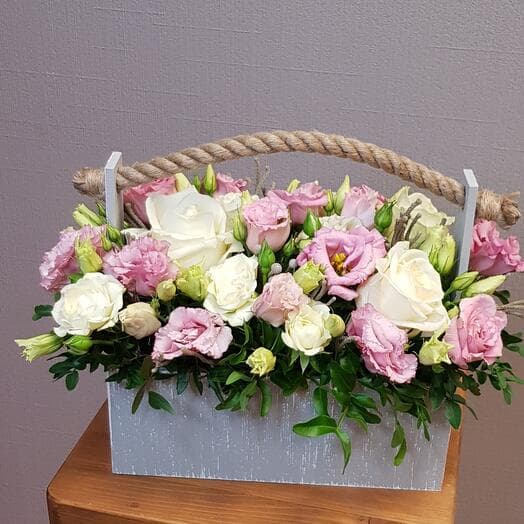 The composition in a box with a white rose and pink east