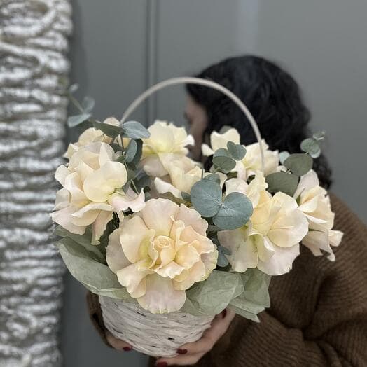 Basket with roses and eucalyptus
