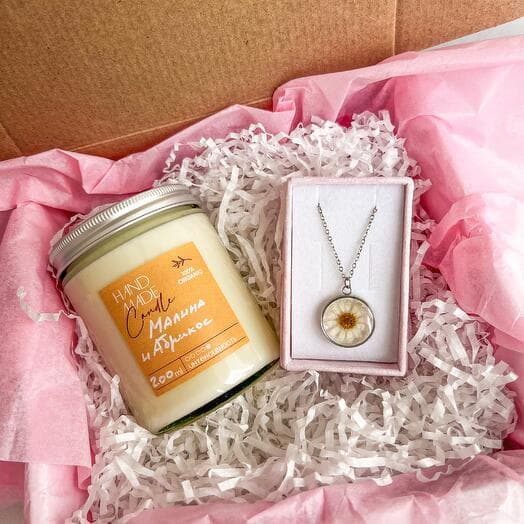 A birthday gift with a pendant and candles