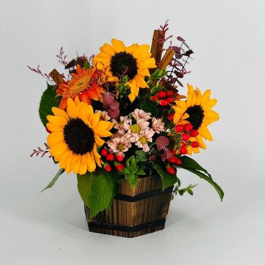 Autumn bouquet of flowers with sunflower with wooden pots