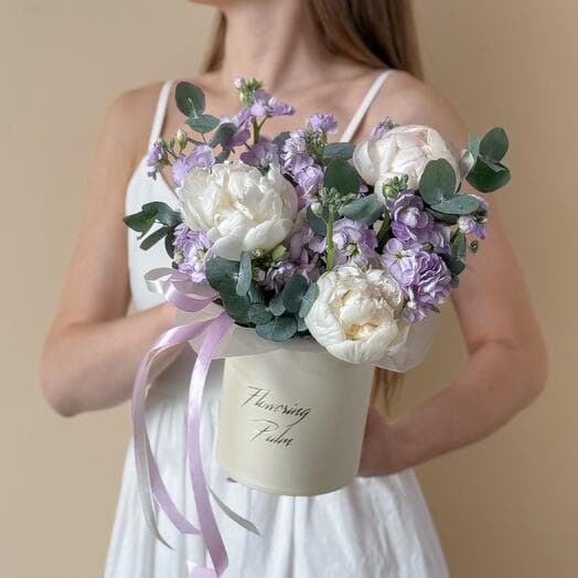 Box with delicate peonies and a bush mattio