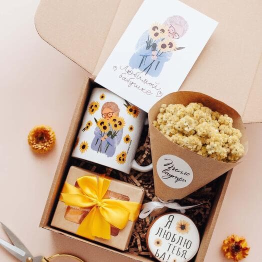 Gift set of her beloved grandmother with flowers, mug, sweets and gingerbread