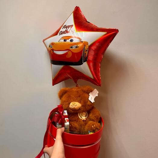 A gift to a boy with a machine, a bear, a gel ball and kinders