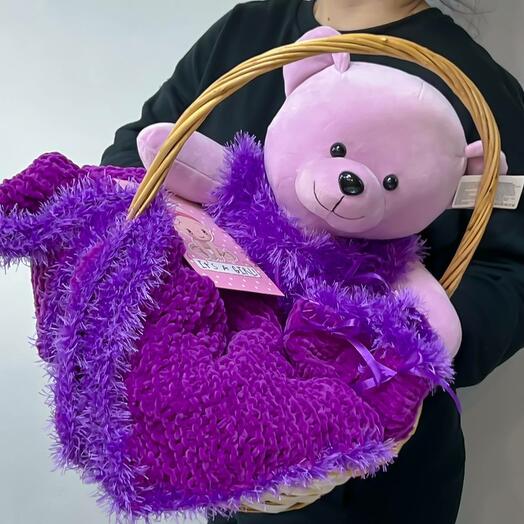 Gift set for a newborn girl in a wicker basket