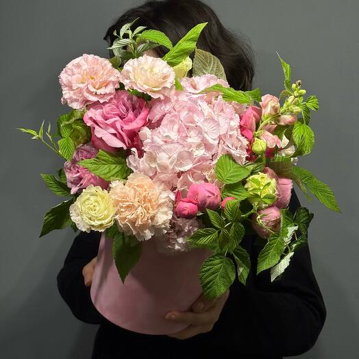 Flower composition in a box with eusta, roses and raspberries
