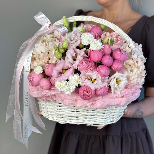Basket with flowers pionivate pink roses, hydrangea, bush diatus