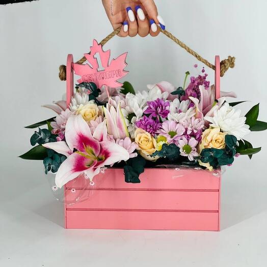 Flower composition in a wooden pot for September 1