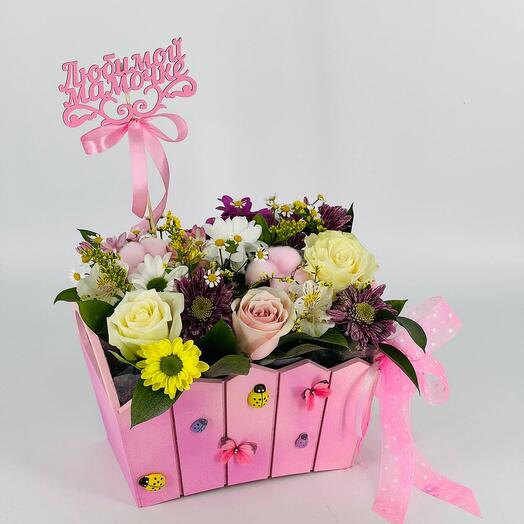 Bouquet of flowers in pink wooden pots as a gift to mom