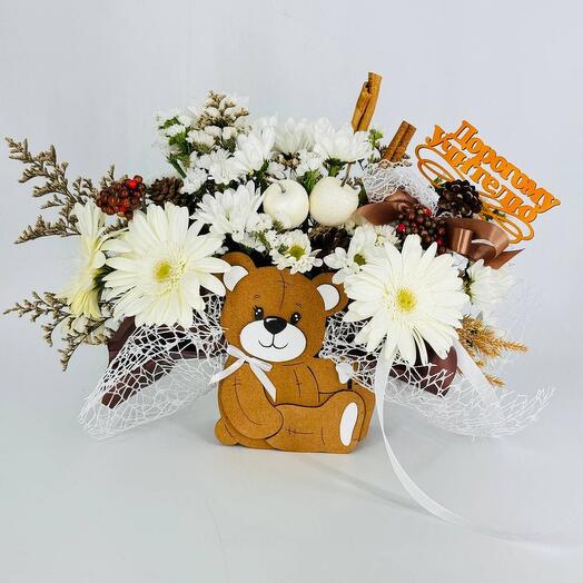 Book of flowers with cones and mountain ash in a kashpo bear as a gift to an expensive teacher