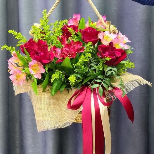Flower composition of roses and alstromeria in a wooden box