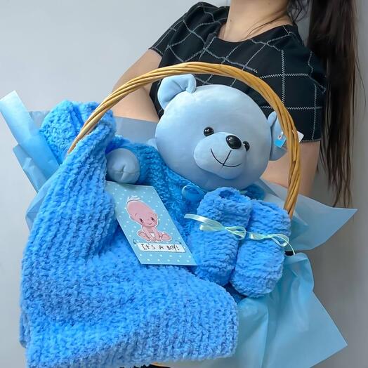 Gift set for a newborn boy in a wicker basket