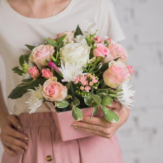 Delicate composition of roses in a pink box
