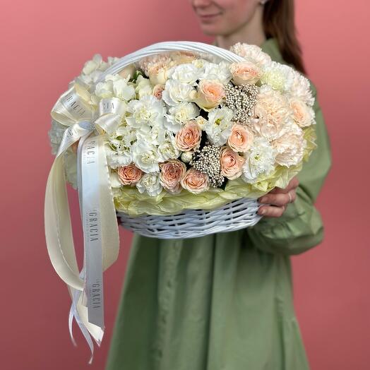 Basket with flowers delicate pionivate roses, hydrangea, fluffy diantus and curly eastoma
