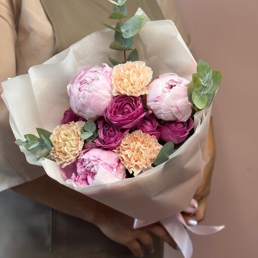 Author's bouquet with peonies of diatus and pionivate bush rose