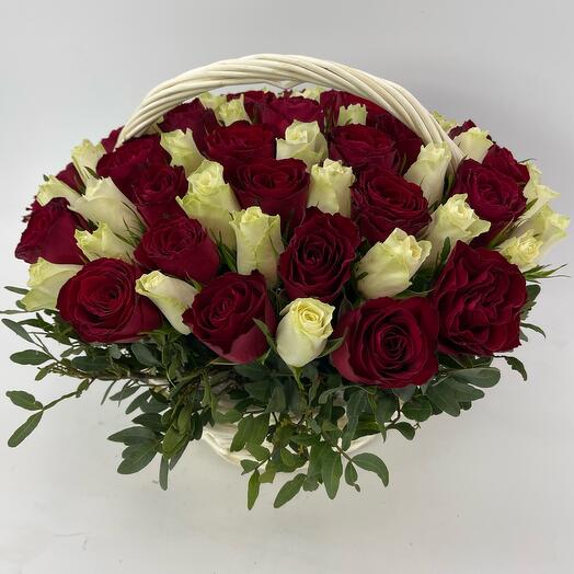 A composition of 75 white and burgundy roses atena and explorer in a wicker basket