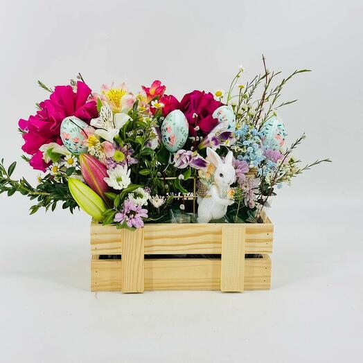 Flower composition with a living verba hare and eggs in a wooden pot