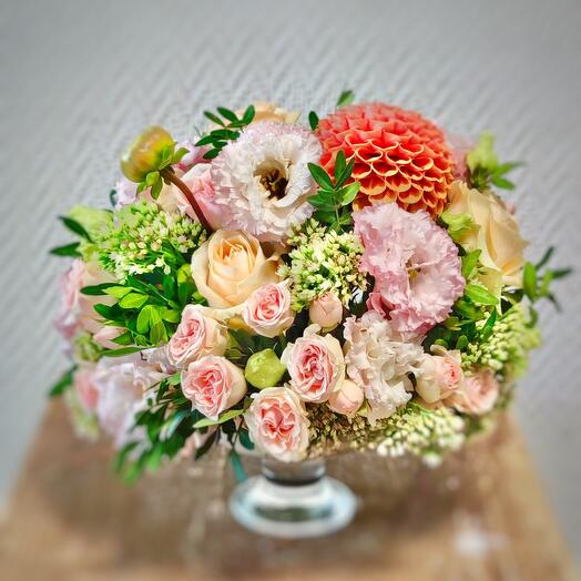 The composition on the table with seasonal flowers