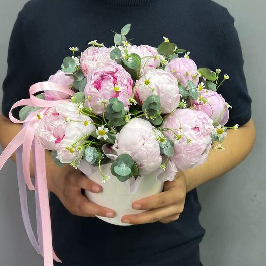 Peonies with chamomile and eucalyptus in a hat box