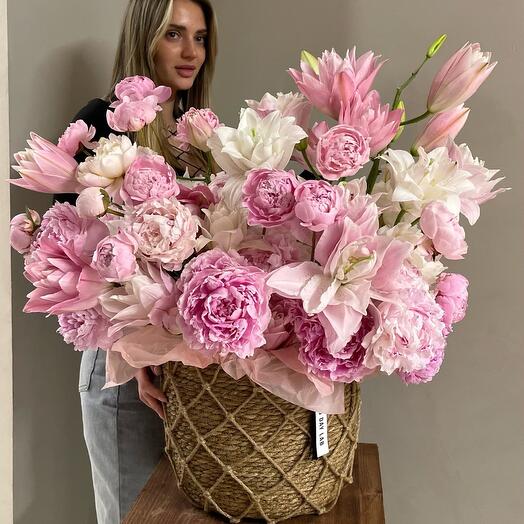 Luxurious basket made of fragrant peony lilies and peonies