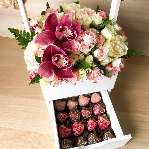 The composition of flowers and strawberries in chocolate in a wooden box m