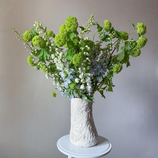 Blooming branches of Viburnum with dolphinium for the interior