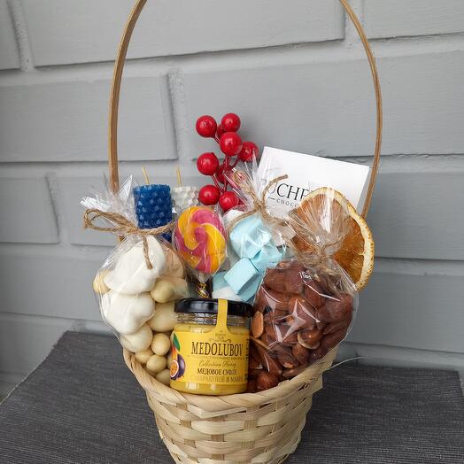 Sunny basket with nuts, sweets and candles