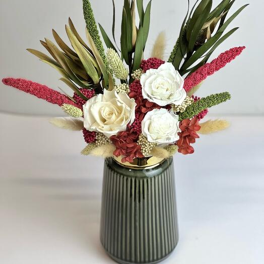 Author's composition with dried flowers in a ceramic vase