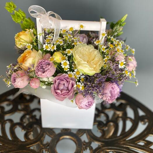 Flowers in a box with peonies of days by rose and lysianthus