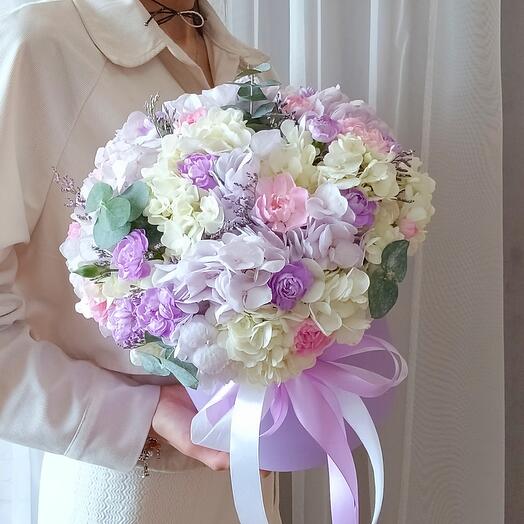 Flowers in the box. Gorgeous composition of flowers in a hat box. A gift to a woman