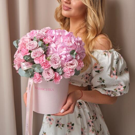 Flowers in the box. Tender composition of bush roses, pink hydrangea and eucalyptus branches