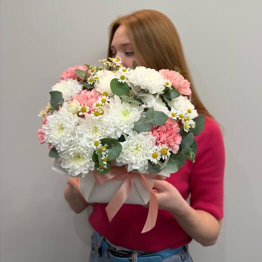 Bouquet on an oasis from chrysanthemums, daisies and pink dianths