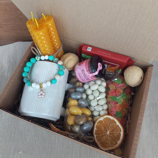 Gift set with natural bracelets, nuts, honey, chocolate and candles