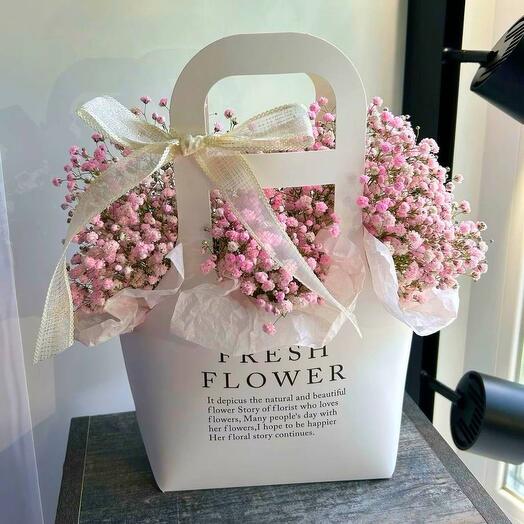 Directly pink gypsophila in a purse as a gift to her friend, mother, girl