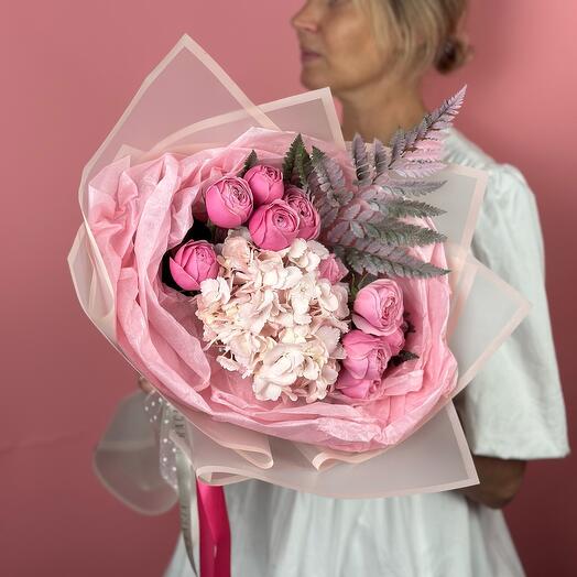 Bouquet of lush hydrangea, pionoid delicate roses and decorative fern